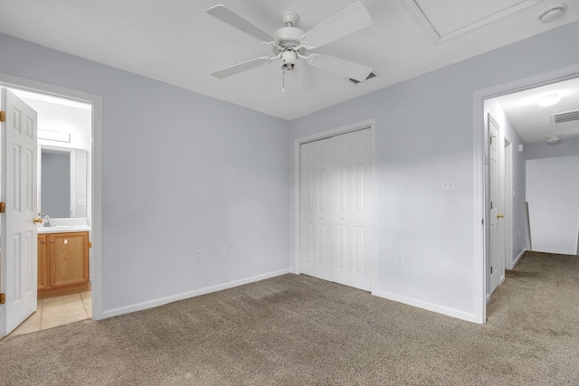 2738 W Tharpe St Unit 806, Tallahassee, FL 32303 - unfurnished bedroom featuring light colored carpet, a closet, connected bathroom, and ceiling fan