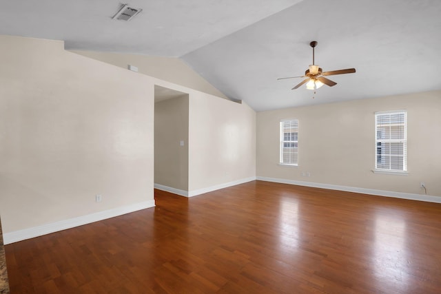 unfurnished room featuring a healthy amount of sunlight, dark wood finished floors, a ceiling fan, and lofted ceiling