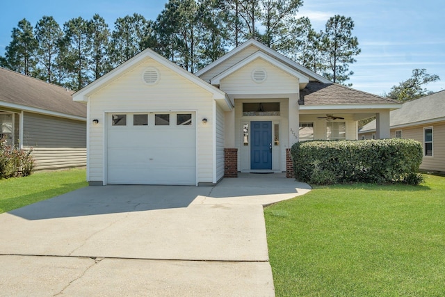 view of front of house featuring driveway, a front lawn, roof with shingles, and an attached garage