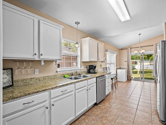 100 Ej Stringer Rd, Crawfordville, FL 32327 - kitchen with appliances with stainless steel finishes, white cabinetry, lofted ceiling, pendant lighting, and light tile patterned floors