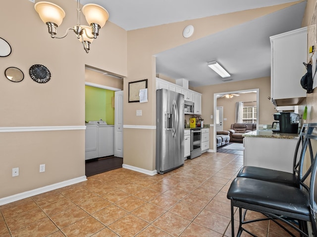 100 Ej Stringer Rd, Crawfordville, FL 32327 - kitchen featuring stainless steel appliances, independent washer and dryer, white cabinets, and light tile patterned flooring