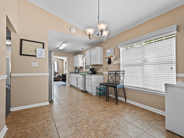 100 Ej Stringer Rd, Crawfordville, FL 32327 - kitchen featuring plenty of natural light, white cabinets, a chandelier, and appliances with stainless steel finishes
