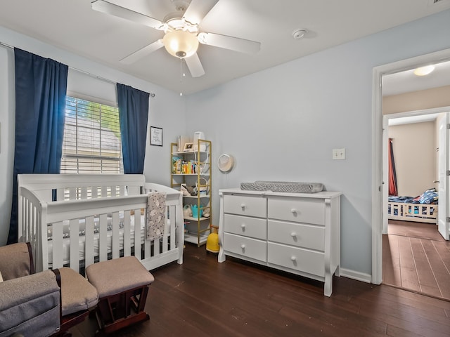 100 Ej Stringer Rd, Crawfordville, FL 32327 - bedroom with hardwood / wood-style floors, a nursery area, and a ceiling fan