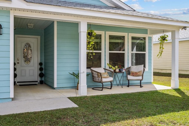 view of exterior entry featuring a lawn