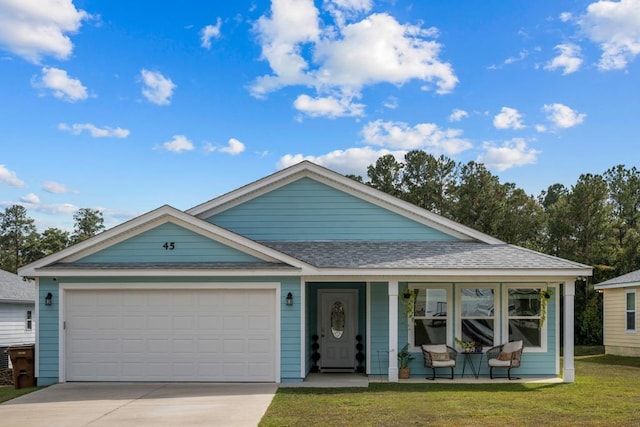 view of front of property with a garage and a front yard