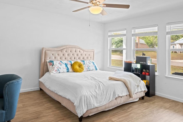 bedroom with wood-type flooring and ceiling fan