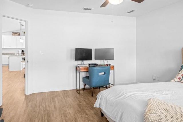 bedroom featuring ceiling fan, light hardwood / wood-style flooring, and vaulted ceiling