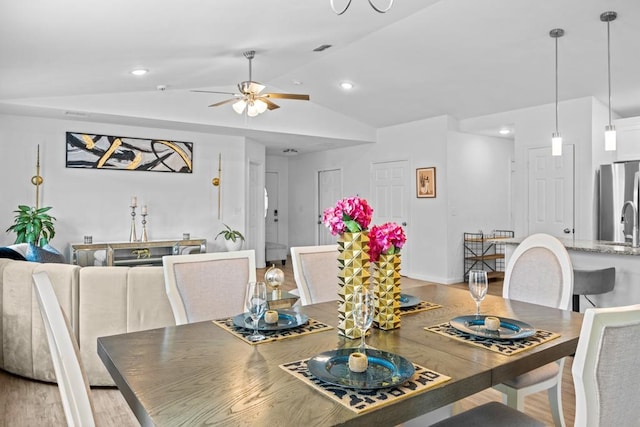 dining space with lofted ceiling, wood-type flooring, and ceiling fan