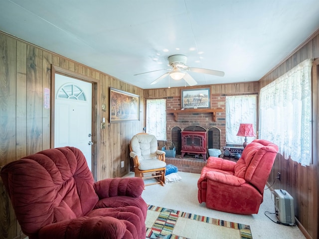 3364 NW 66th Blvd, Jennings, FL 32053 - living room with wooden walls, plenty of natural light, a ceiling fan, a fireplace, and carpet flooring