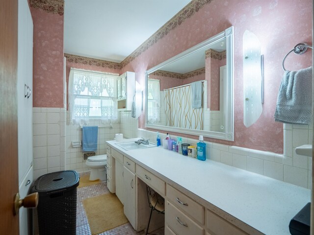 3364 NW 66th Blvd, Jennings, FL 32053 - full bathroom with wallpapered walls, toilet, vanity, a wainscoted wall, and tile patterned flooring