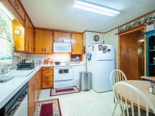 3364 NW 66th Blvd, Jennings, FL 32053 - kitchen featuring white appliances, light flooring, light countertops, brown cabinets, and a sink