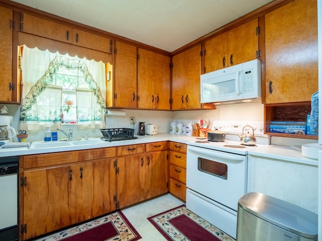 3364 NW 66th Blvd, Jennings, FL 32053 - kitchen featuring white appliances, light countertops, and brown cabinets