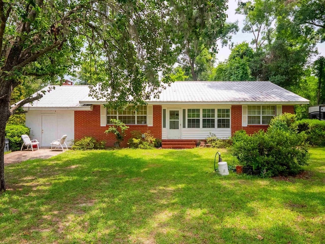 3364 NW 66th Blvd, Jennings, FL 32053 - single story home with brick siding, a front lawn, a patio area, and metal roof