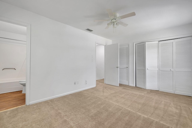 2263 Shady Timbers Cir Unit 3, Tallahassee, FL 32304 - unfurnished bedroom featuring multiple closets, visible vents, ensuite bath, baseboards, and carpet flooring
