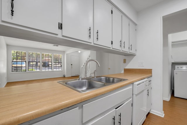 2263 Shady Timbers Cir Unit 3, Tallahassee, FL 32304 - kitchen featuring white cabinets, a sink, baseboards, white dishwasher, and washer / dryer
