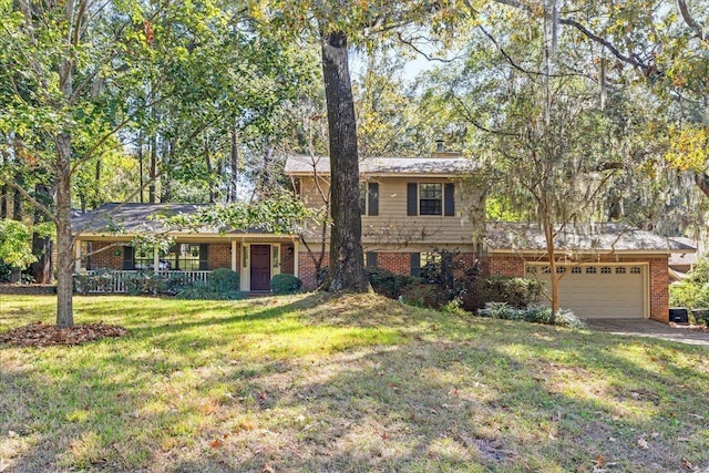 split level home featuring a front yard, a garage, and covered porch