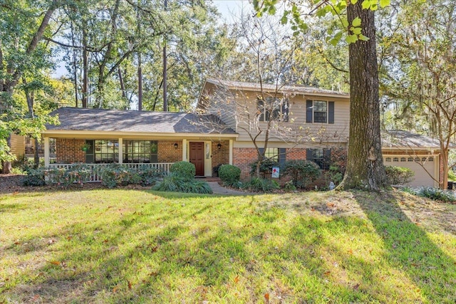 view of front of house with a garage, covered porch, and a front yard