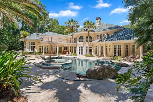 3899 W Millers Bridge Rd, Tallahassee, FL 32312 - back of property with french doors, a balcony, a patio, a chimney, and a tiled roof