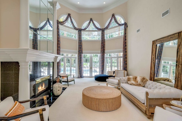 3899 W Millers Bridge Rd, Tallahassee, FL 32312 - living area with a fireplace, a towering ceiling, plenty of natural light, ornamental molding, and carpet floors