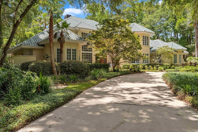3899 W Millers Bridge Rd, Tallahassee, FL 32312 - view of front of house with a chimney, a tile roof, and stucco siding