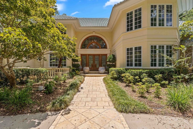 3899 W Millers Bridge Rd, Tallahassee, FL 32312 - property entrance featuring french doors, stucco siding, and a tiled roof