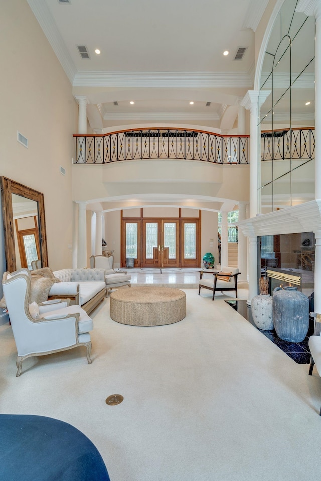 3899 W Millers Bridge Rd, Tallahassee, FL 32312 - carpeted living area featuring crown molding, a high ceiling, a tile fireplace, and ornate columns