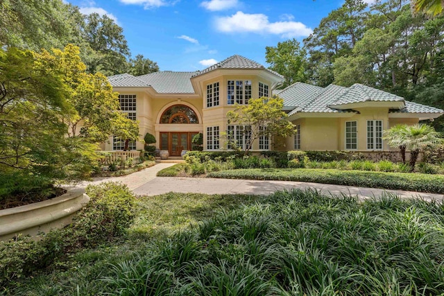 3899 W Millers Bridge Rd, Tallahassee, FL 32312 - mediterranean / spanish home featuring french doors, stucco siding, and a tiled roof