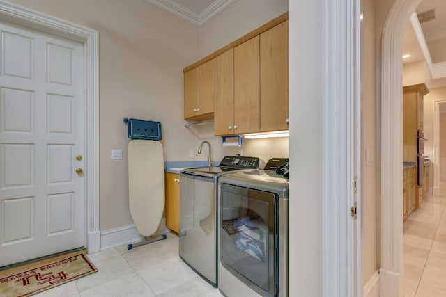 3899 W Millers Bridge Rd, Tallahassee, FL 32312 - washroom with cabinet space, washer and dryer, light tile patterned floors, crown molding, and arched walkways