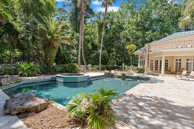 3899 W Millers Bridge Rd, Tallahassee, FL 32312 - view of pool featuring french doors, a patio, a pool with connected hot tub, and view of wooded area