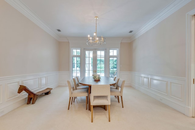 3899 W Millers Bridge Rd, Tallahassee, FL 32312 - dining room featuring a chandelier, light carpet, a decorative wall, crown molding, and wainscoting