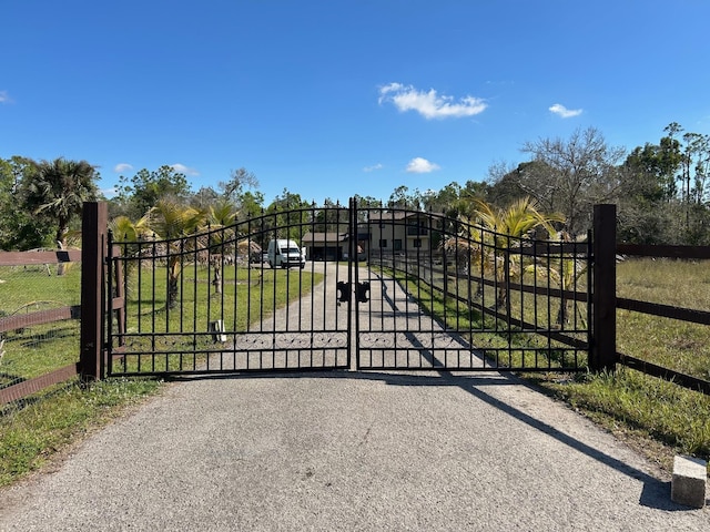 view of gate featuring a lawn