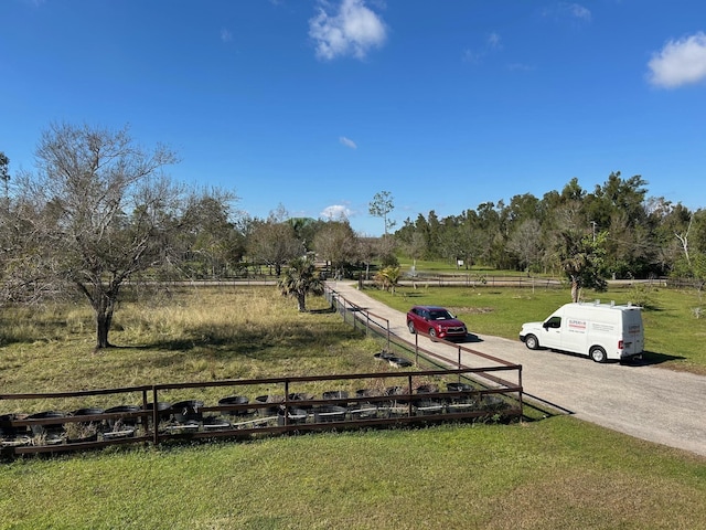 view of home's community with a lawn and a rural view