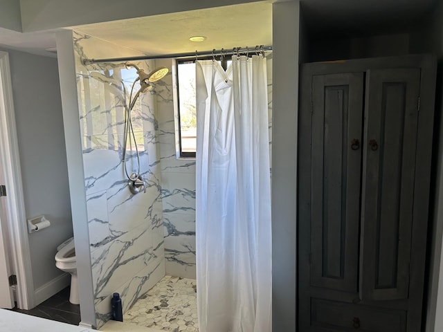 bathroom with curtained shower and toilet