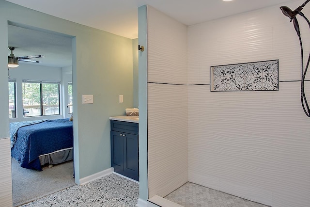 bathroom featuring vanity, tile patterned floors, ceiling fan, and tiled shower