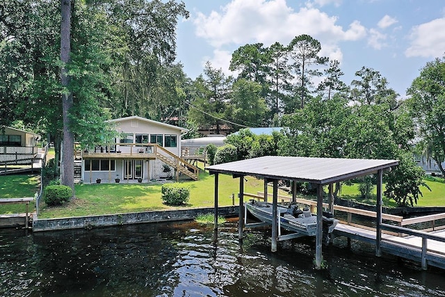 dock area featuring a deck with water view and a lawn