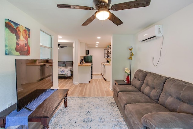 living room featuring light hardwood / wood-style floors and a wall mounted air conditioner