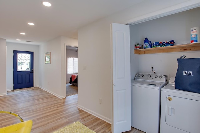 washroom featuring ceiling fan, washing machine and dryer, and light hardwood / wood-style floors