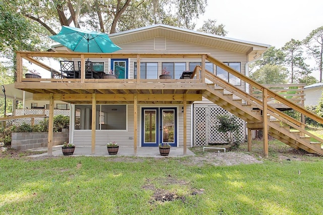 rear view of property with a yard and a wooden deck