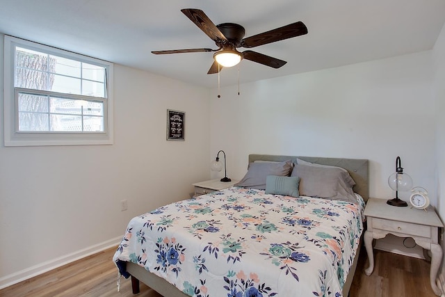 bedroom featuring light wood-type flooring and ceiling fan