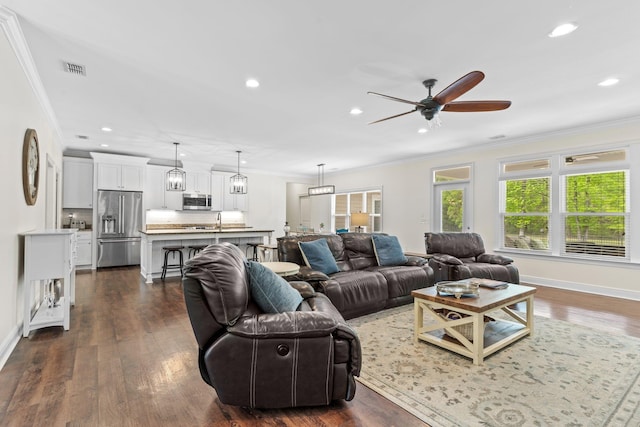 living room with recessed lighting, dark wood-style flooring, visible vents, and crown molding