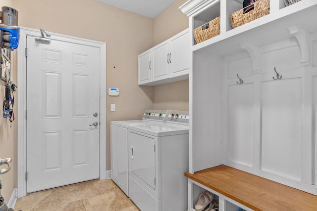 washroom with washer and dryer and cabinet space