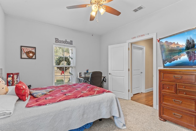 bedroom featuring ceiling fan, light carpet, and visible vents