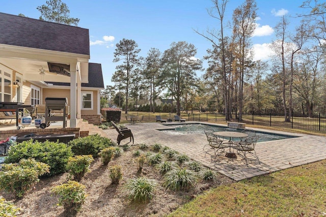 exterior space with a fenced in pool, a patio area, fence, and a ceiling fan