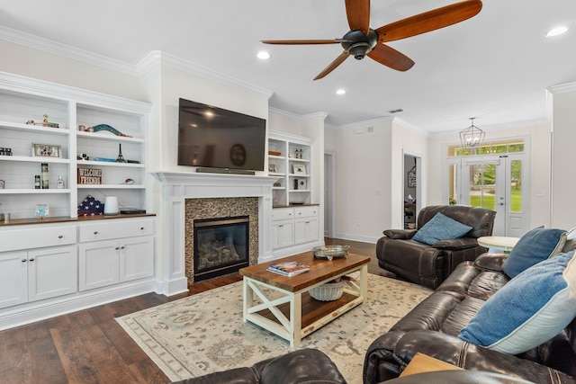 living area featuring recessed lighting, dark wood-type flooring, a fireplace, baseboards, and ornamental molding