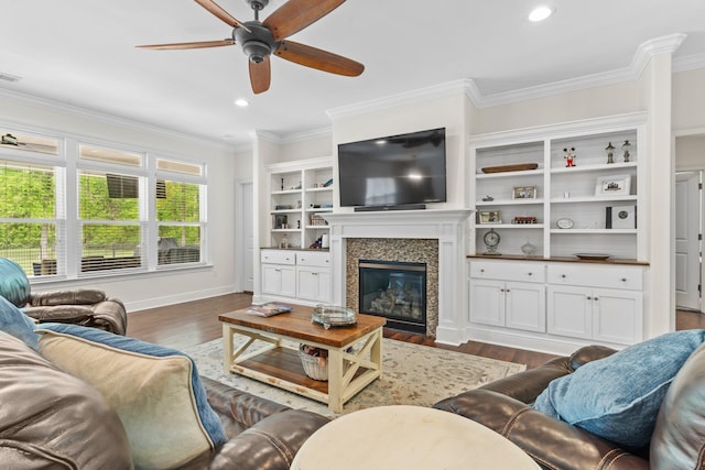 living area with crown molding, dark wood-type flooring, and a high end fireplace