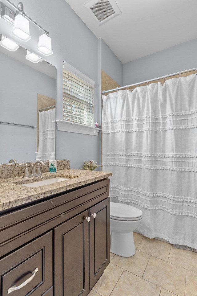 full bathroom with toilet, vanity, visible vents, and tile patterned floors