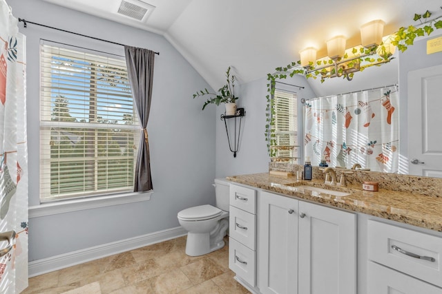 bathroom featuring toilet, vanity, visible vents, vaulted ceiling, and baseboards