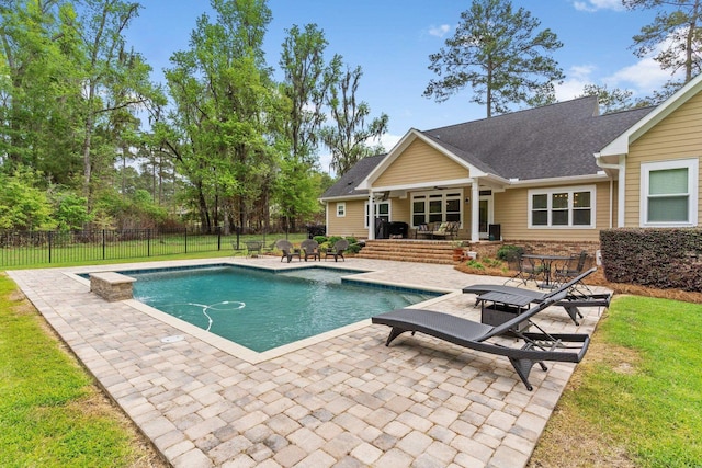 view of pool featuring a patio, a lawn, fence, and a fenced in pool