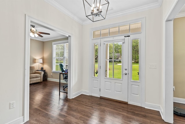 foyer featuring baseboards, dark wood-style flooring, a notable chandelier, and crown molding