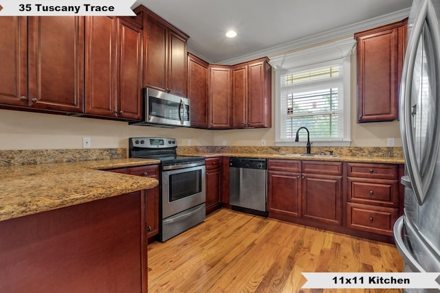 kitchen featuring light wood-type flooring, light stone counters, stainless steel appliances, crown molding, and sink